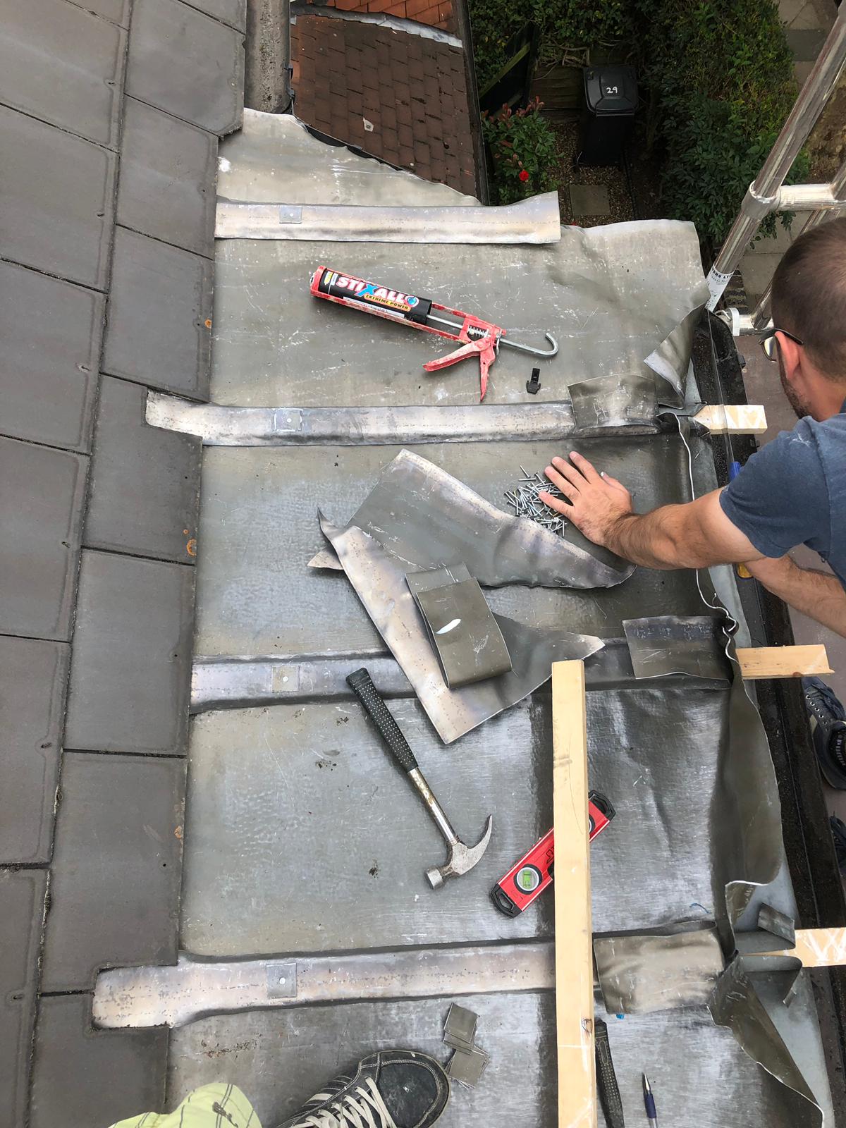 Craftsman carrying out detailed restoration work on a period timber sash window